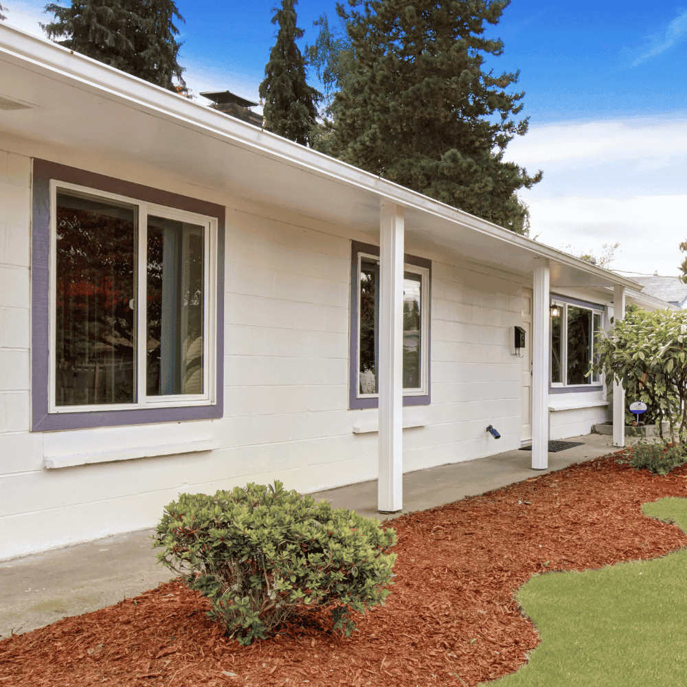 White house façade, shrubs and lawn
